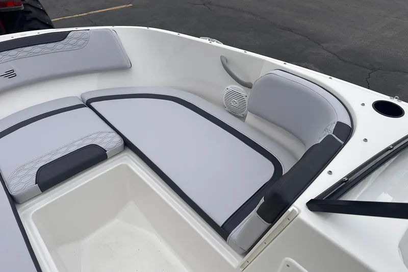 Slide: The Image of 2026 Bayliner M17 boat interior with cushioned seating and speaker system. - 11