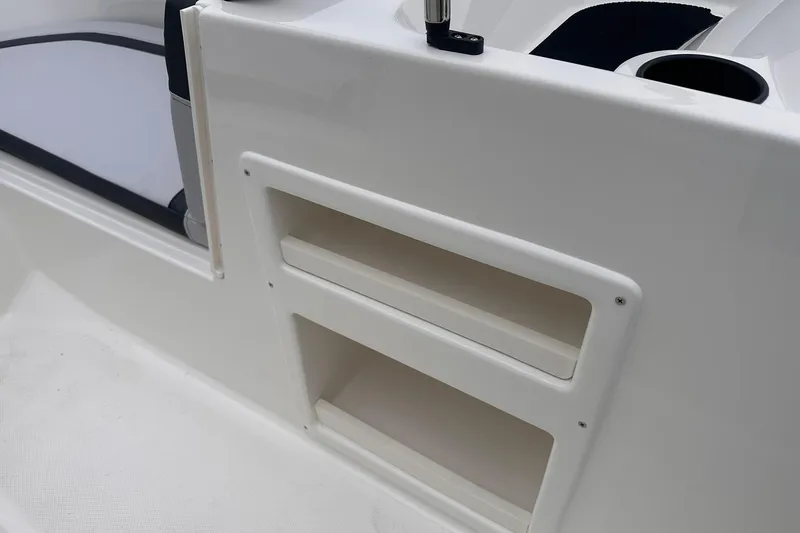 Slide: The Image of 2026 Bayliner M17 boat interior with storage compartments and seating area. - 16