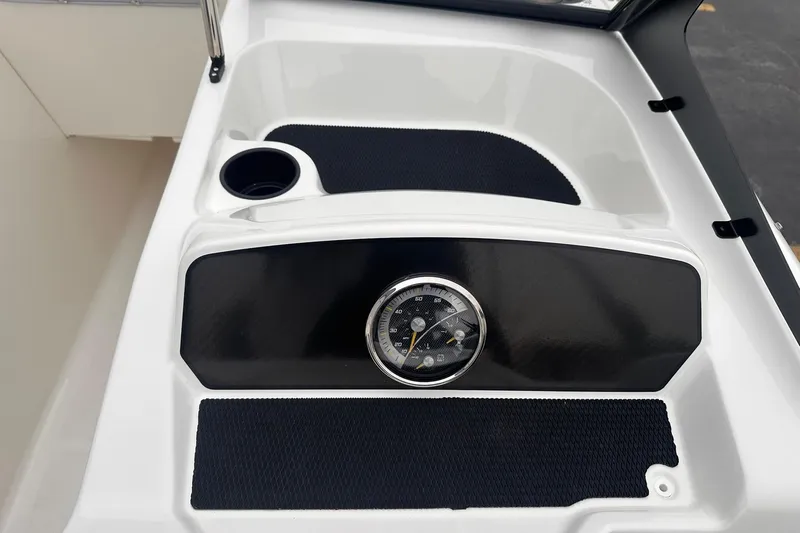 Slide: The Image of 2026 Bayliner M17 dashboard with speedometer and cup holder, featuring sleek black and white design. - 21