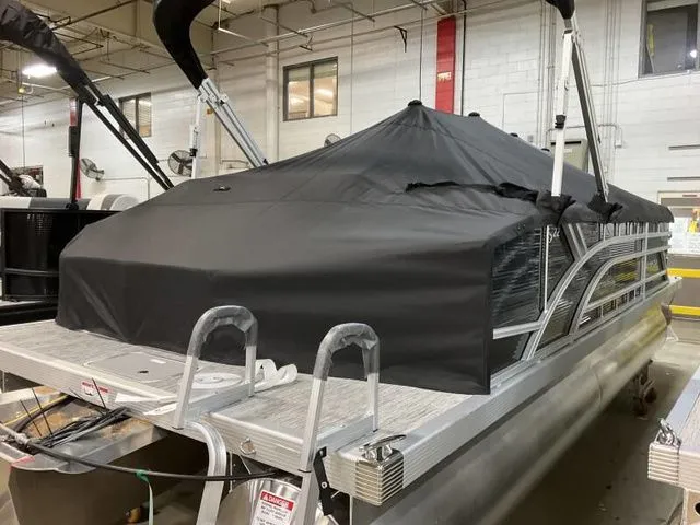 Slide: The Image of 2025 Bennington 22 SSB pontoon boat with cover in warehouse. - 11