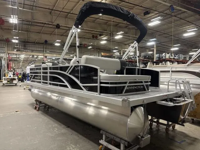 Slide: The Image of 2025 Bennington 22 SSB pontoon boat in a factory setting. - 3