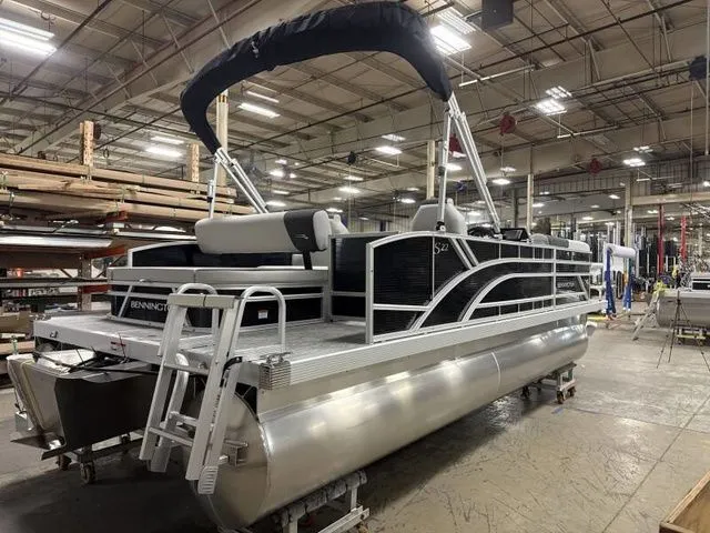 Slide: The Image of 2025 Bennington 22 SSB pontoon boat in a factory setting. - 5