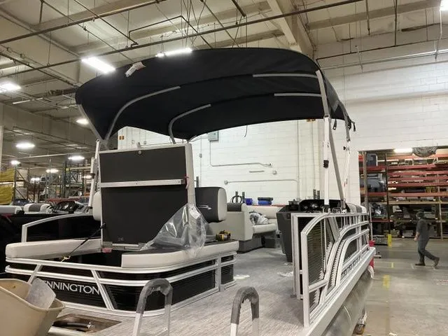 Slide: The Image of Bennington 22 SSB 2025 pontoon boat in a factory setting. - 6