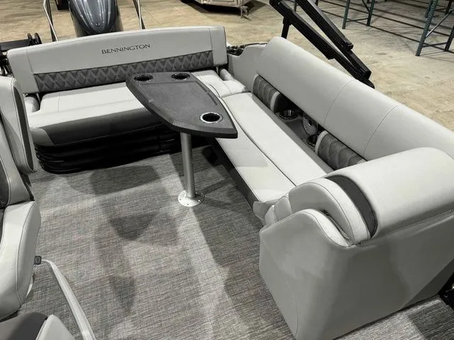Slide: The Image of 2024 Bennington LXS Series 23 LXSSB interior with gray seating and table. - 9