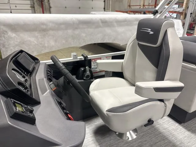 Slide: The Image of Interior of 2026 Bennington 22 SSR with helm console and captain's chair. - 8