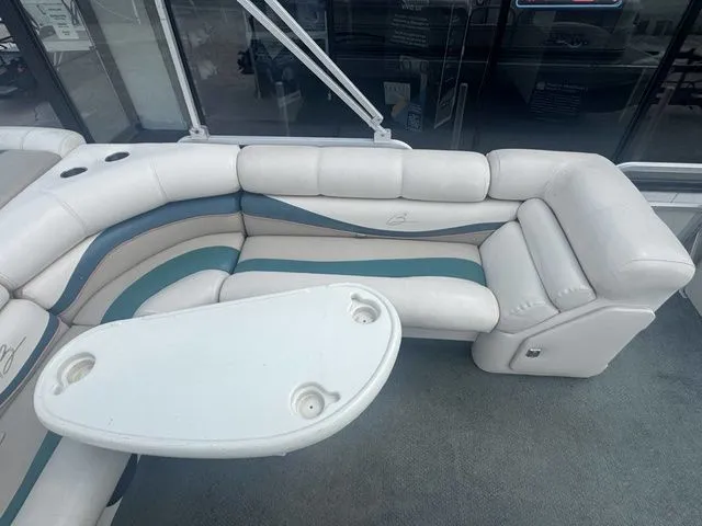 Slide: The Image of Interior of a 2000 Bennington 2080 LX pontoon boat with white seating area. - 12