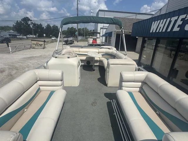 Slide: The Image of 2000 Bennington 2080 LX pontoon boat parked outside a store. - 5