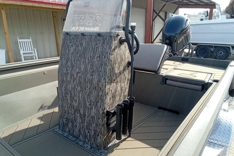 Slide: The Image of 2026 Thor 1900 Low Country Elite boat with camo console and outboard motor. - 10