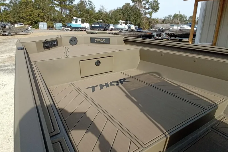 Slide: The Image of 2026 Thor 1900 Low Country Elite boat interior, featuring spacious deck and storage. - 11