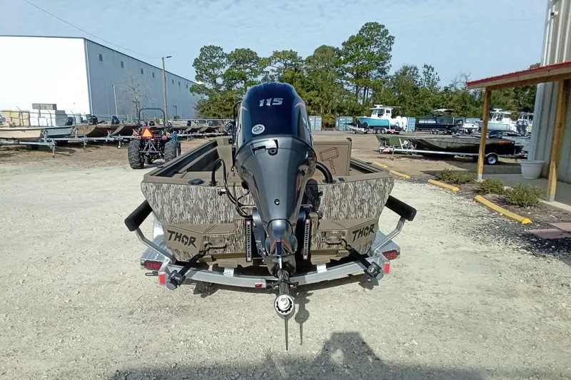 Slide: The Image of 2026 Thor 1900 Low Country Elite boat with 115 HP engine, parked outdoors. - 14