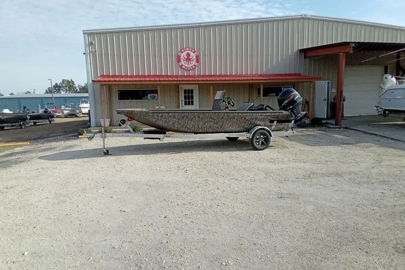 Slide: The Image of 2026 Thor 1900 Low Country Elite boat on trailer outside dealership. - 2