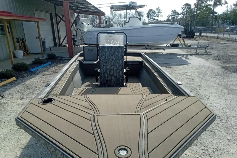 Slide: The Image of 2026 Thor 1900 Low Country Elite boat with sleek design, parked outdoors. - 8