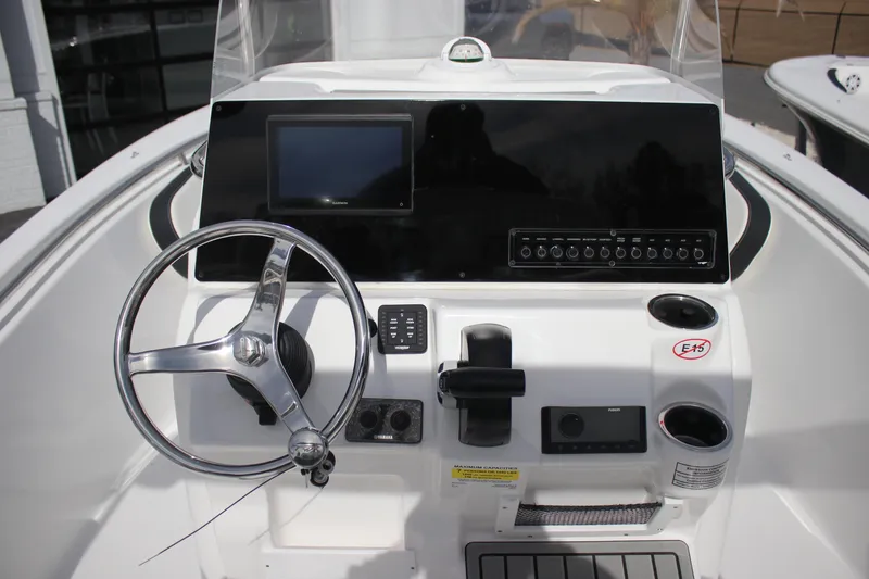 Slide: The Image of 2026 Tidewater 198 CC Adventure boat dashboard with steering wheel and control panel. - 19