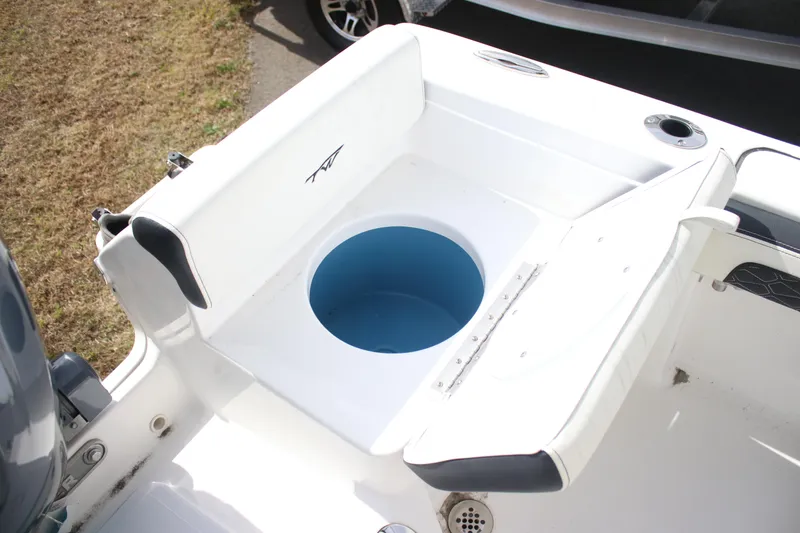 Slide: The Image of 2026 Tidewater 198 CC Adventure boat with open storage compartment and seating. - 27