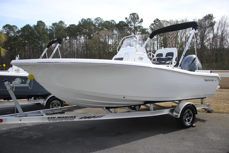 Slide: The Image of 2026 Tidewater 198 CC Adventure boat on trailer, parked outdoors. - 3