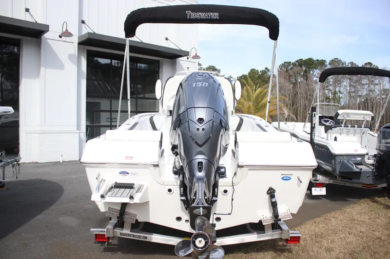 Slide: The Image of 2026 Tidewater 198 CC Adventure boat with powerful outboard motor, parked outdoors. - 7
