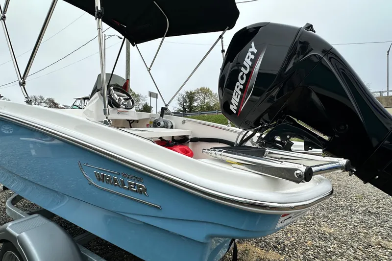 Slide: The Image of 2026 Boston Whaler 130 Super Sport with Mercury engine, blue design. - 25