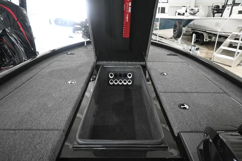 Slide: The Image of 2026 Vexus AVX 1980 boat interior with open storage compartment and carpeted deck. - 11