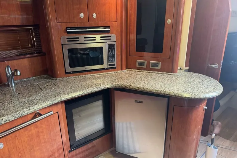 Slide: The Image of Luxurious 2005 Sea Ray 420 Sundancer yacht kitchen with granite countertops and modern appliances. - 10