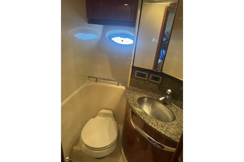 Slide: The Image of Luxurious bathroom in 2005 Sea Ray 420 Sundancer yacht with granite countertop and porthole. - 18