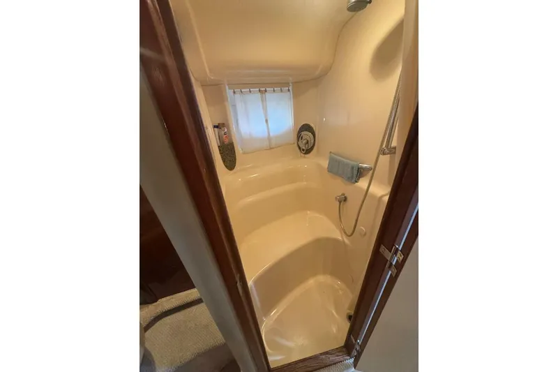 Slide: The Image of Shower area inside 2005 Sea Ray 420 Sundancer yacht, featuring compact design and amenities. - 20