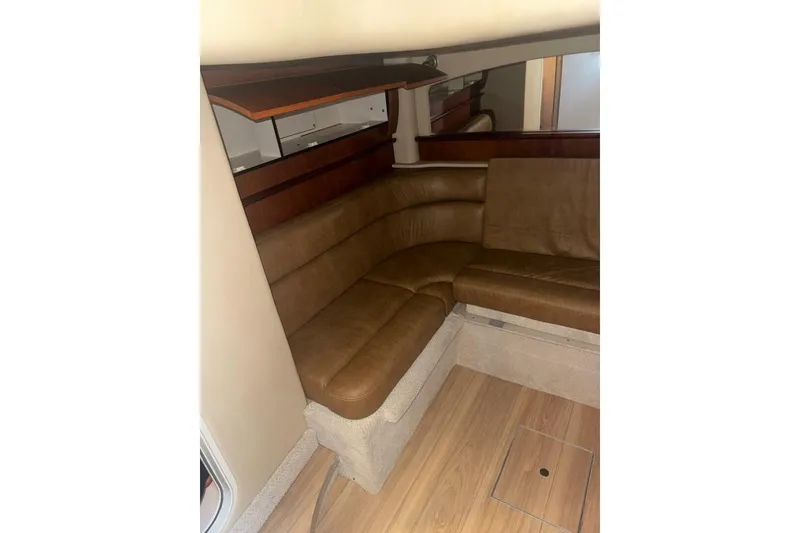 Slide: The Image of Interior of 2005 Sea Ray 420 Sundancer with brown leather seating and wood accents. - 21