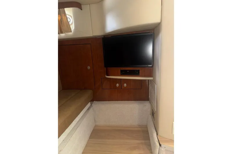 Slide: The Image of 2005 Sea Ray 420 Sundancer interior with TV and wooden cabinetry. - 22