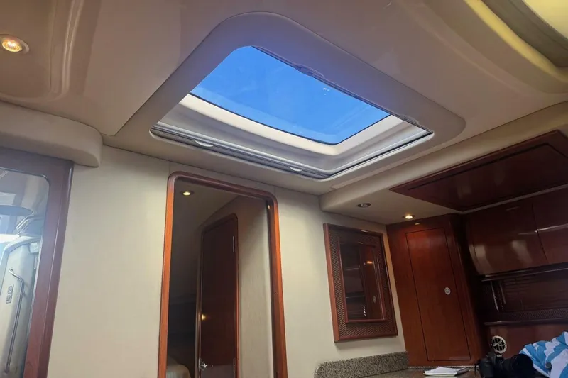 Slide: The Image of Interior view of 2005 Sea Ray 420 Sundancer yacht with skylight and wooden cabinetry. - 23