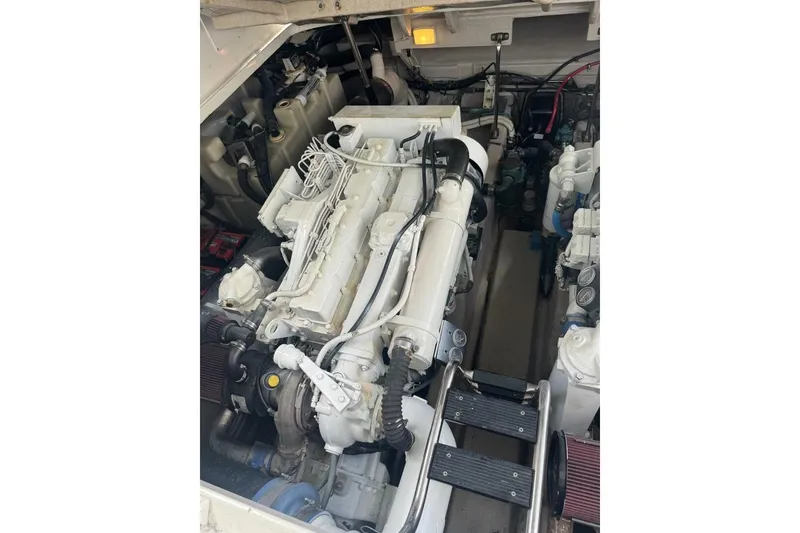 Slide: The Image of Engine compartment of a 2005 Sea Ray 420 Sundancer boat, showcasing detailed machinery. - 24