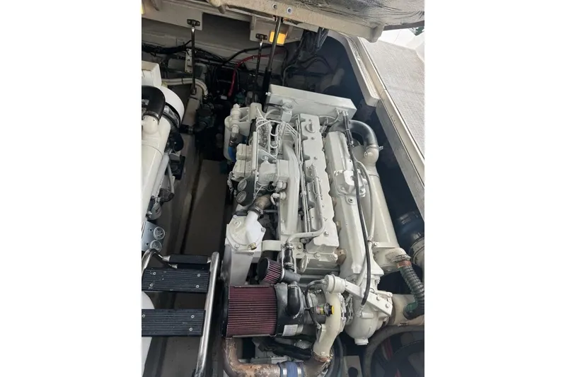 Slide: The Image of Engine compartment of a 2005 Sea Ray 420 Sundancer boat, showcasing detailed machinery. - 25