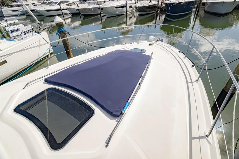 Slide: The Image of 2005 Sea Ray 420 Sundancer yacht docked, featuring sleek deck design and marina view. - 36
