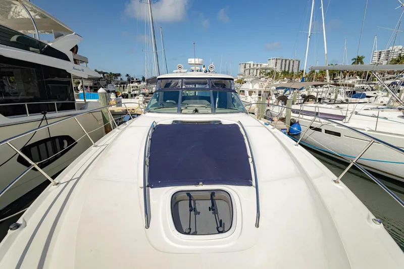 Slide: The Image of 2005 Sea Ray 420 Sundancer yacht docked at marina under clear blue sky. - 37
