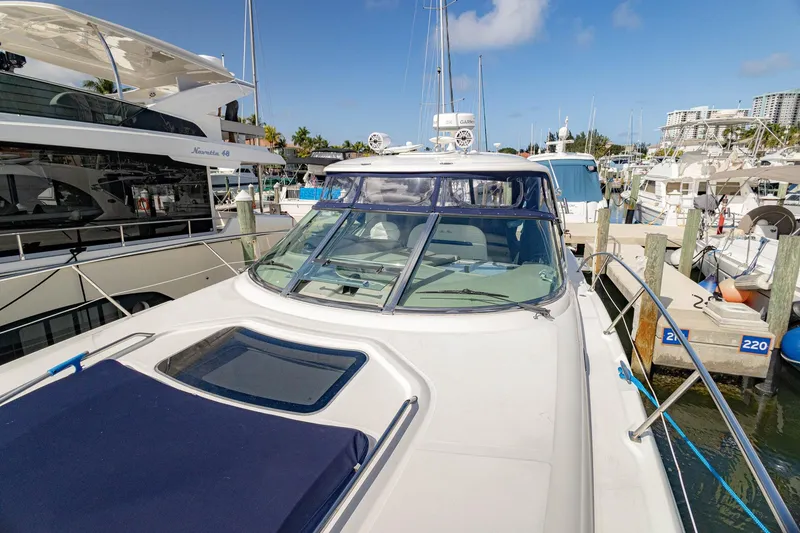 Slide: The Image of 2005 Sea Ray 420 Sundancer yacht docked at marina under clear blue sky. - 38
