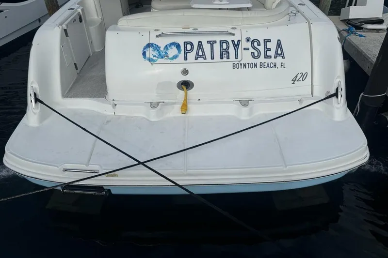Slide: The Image of 2005 Sea Ray 420 Sundancer docked, rear view with "Patry-Sea" name, Boynton Beach, FL. - 4