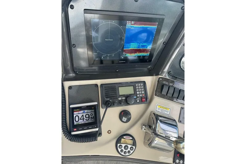 Slide: The Image of Control panel of a 2005 Sea Ray 420 Sundancer with navigation and communication equipment. - 8