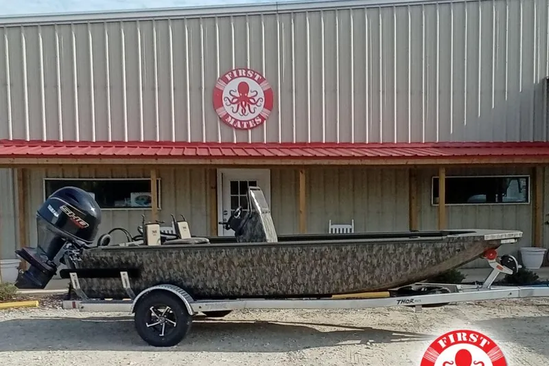 Slide: The Image of 2026 Thor 1900 Low Country Elite boat on trailer outside First Mates building. - 0