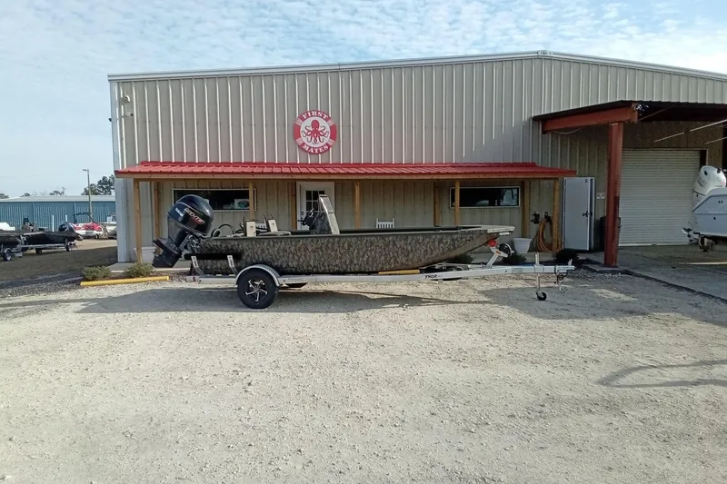 Slide: The Image of 2026 Thor 1900 Low Country Elite boat on trailer outside a metal building. - 1