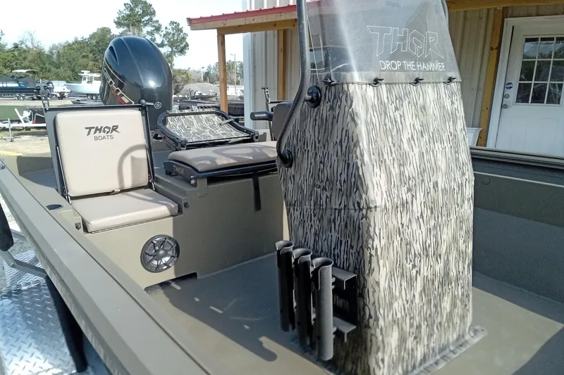 Slide: The Image of 2026 Thor 1900 Low Country Elite boat with camouflage console and seating. - 10