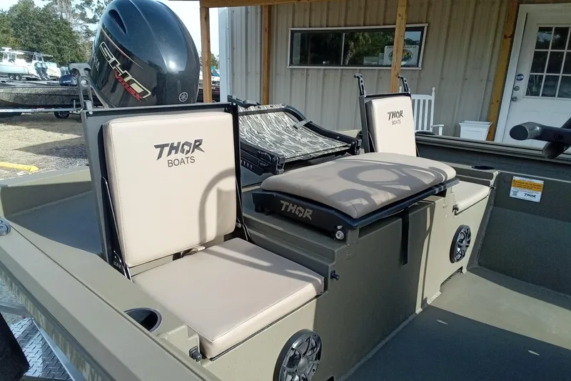 Slide: The Image of 2026 Thor 1900 Low Country Elite boat with cushioned seats and motor. - 11
