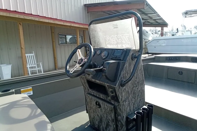 Slide: The Image of Steering console of 2026 Thor 1900 Low Country Elite boat, featuring camo design. - 12