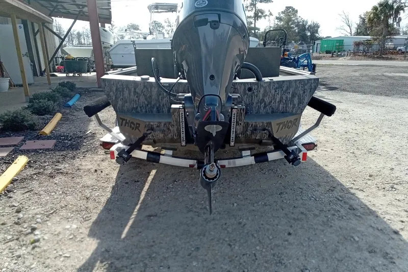 Slide: The Image of 2026 Thor 1900 Low Country Elite boat on trailer, rear view, outdoors. - 15