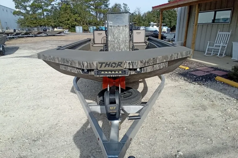 Slide: The Image of 2026 Thor 1900 Low Country Elite boat on trailer, outdoor setting. - 3