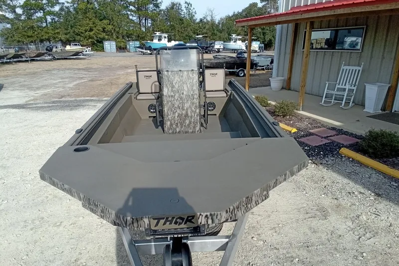 Slide: The Image of 2026 Thor 1900 Low Country Elite boat on display at a dealership. - 4