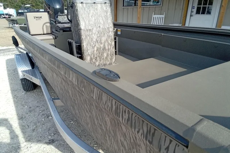 Slide: The Image of 2026 Thor 1900 Low Country Elite boat on trailer, featuring camouflage design. - 7