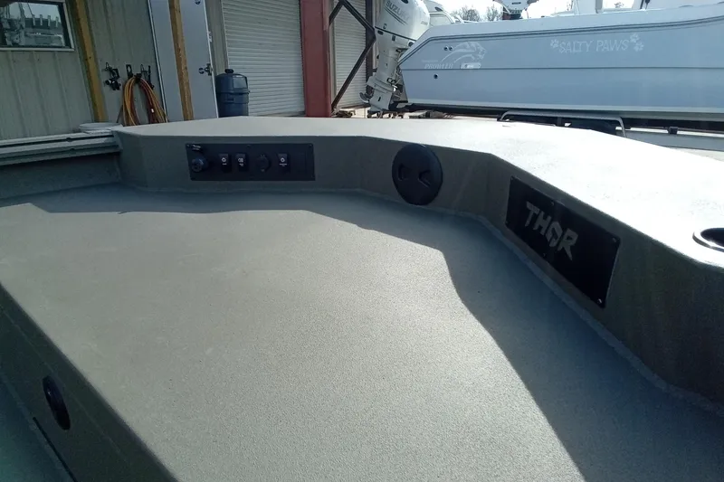 Slide: The Image of 2026 Thor 1900 Low Country Elite boat deck with control panel and branding. - 8