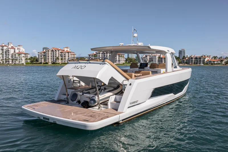 Slide: The Image of 2024 Fjord Boats 53XL luxury yacht on water, with scenic waterfront buildings. - 10