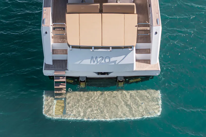 Slide: The Image of 2024 Fjord Boats 53XL rear view with swim platform on clear blue water. - 11