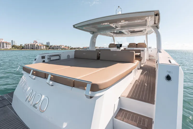 Slide: The Image of 2024 Fjord Boats 53XL luxury yacht with spacious deck and seating, cruising on calm waters. - 12