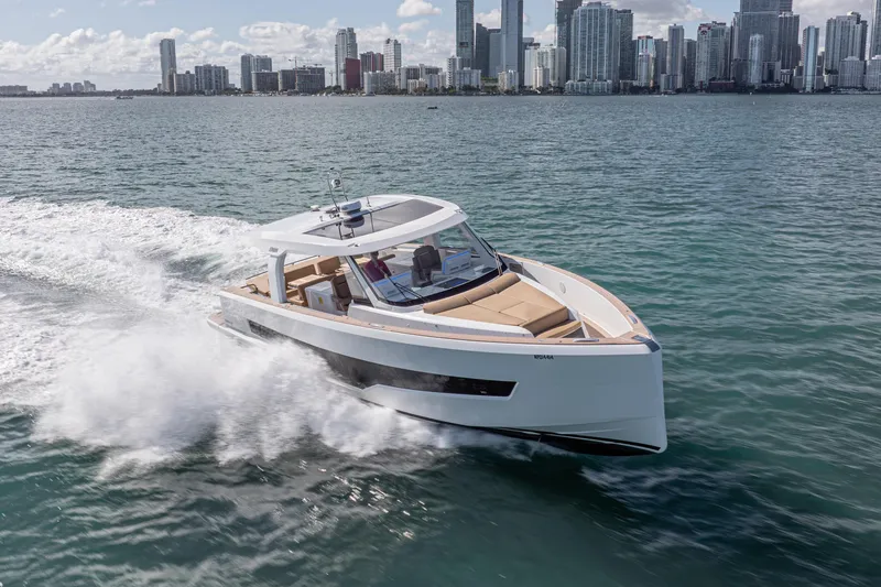 Slide: The Image of 2024 Fjord Boats 53XL cruising near city skyline on a sunny day. - 2