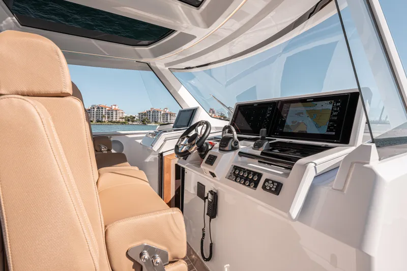 Slide: The Image of 2024 Fjord Boats 53XL helm with advanced navigation displays and luxurious seating. - 25